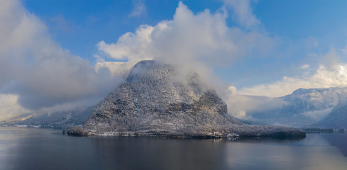 Panorama view of Hallstattersee lake and mountain in daylight with snow. Landscape view of famous Hallstatt lakeside town during winter.  Salzkammergut region, Austria. Januyary2020