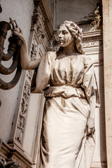 Woman carrying oil with the candlestick in a mausoleum in the Recoleta cemetery in Buenos Aires
