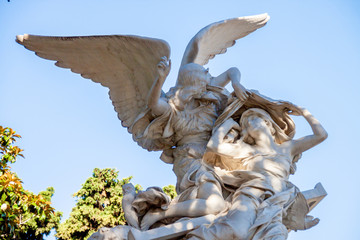 Sculpture of an angel caring for a grave in the Recoleta cemetery in Buenos Aires
