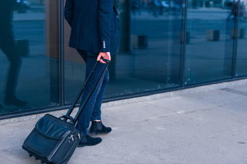 Close up photo a formal businessman dragging his suitcase, manbag, pull bag through a airport...