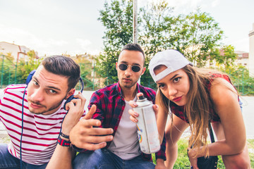 Fototapeta premium Three urban friends looking serious on urban place