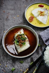 Steamed Fish Flounder in soy sauce and Curry saffron sauce, top view