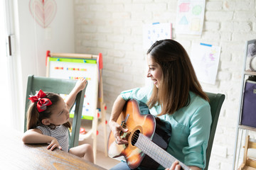 Girl learning with music at home