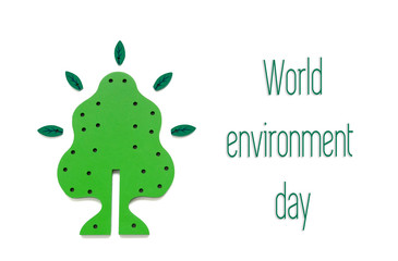 A toy wooden sapling surrounded by wooden leaves on a white background. Concept to world environment day