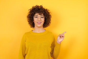 Photo of pretty business woman indicating finger empty space sales manager wear modern stylish yellow sweater isolated yellow color background