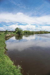 Obraz premium Beautiful spring river in the flowing nature. Colorful landscape in the morning and evening. Travel to deserted places of the world. Stock photo for design