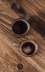 Two glass cup of coffee on rustic textured wooden background. Minimal concept. Top view.