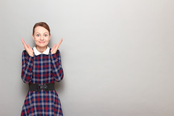 Portrait of happy overjoyed girl raising hands up in triumph