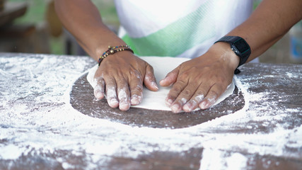 Chef Prepares Dough With Flour To Make a pizza dough rolled out.vintage tone.selective focus.