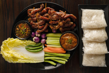 asian and thai style BBQ barbeque pork stick serve with assortment of fresh vegetable and sticky rice, selective focused