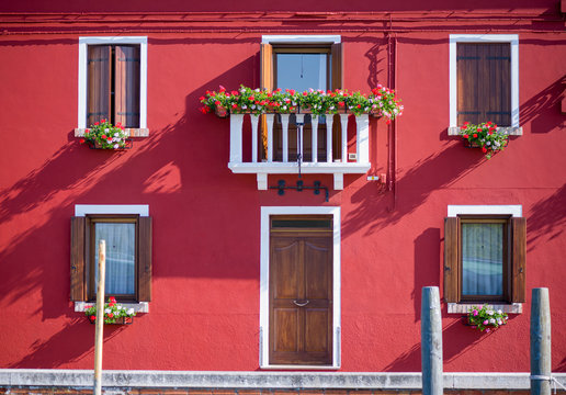Red facace of a house in Burano, Italy.