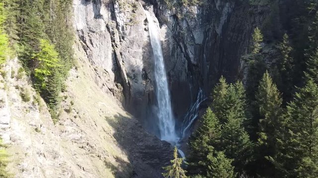 stunnig drone view of a waterfall in the swiss alps (Pochtenfall)