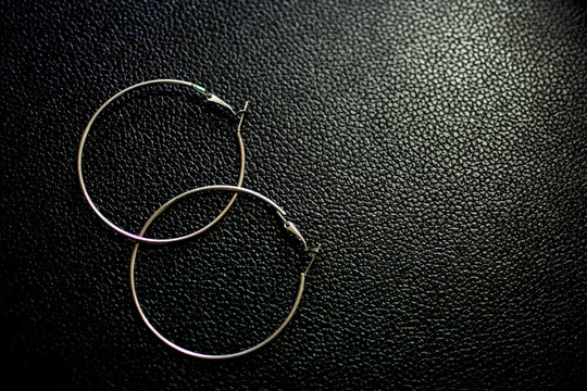 silver hoops with black leather bottom