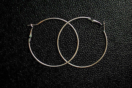 silver hoops with black leather bottom