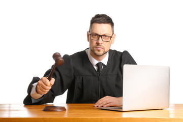 Strict male judge at table on white background