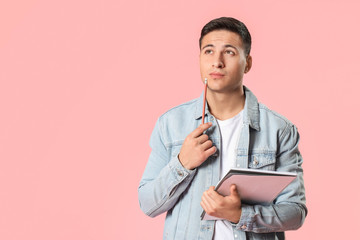 Portrait of male student on color background
