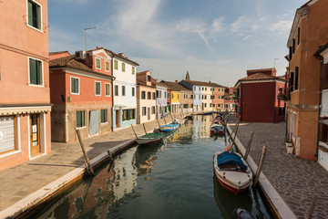 Panoramic view of Burano channel with hanged clothes and colorful houses, in Venice, Italy.