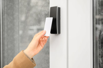 Woman opening door with security card from the outside