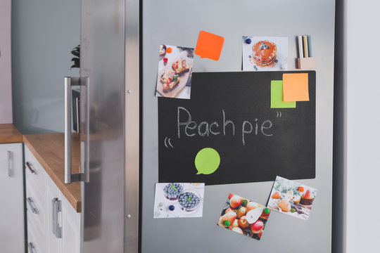 Chalkboard On Door Of Modern Refrigerator In Kitchen