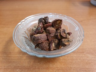 Dried Hawthorn herbal tea on wood background