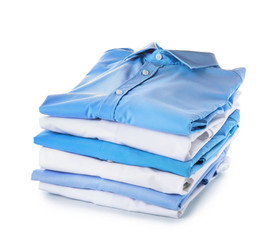 Stack of clean clothes on white background