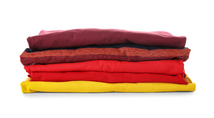 Stack of clean clothes on white background