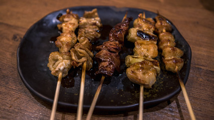 Pork skewers then grilled. Yakitori are a Japanese food in izakaya bar.