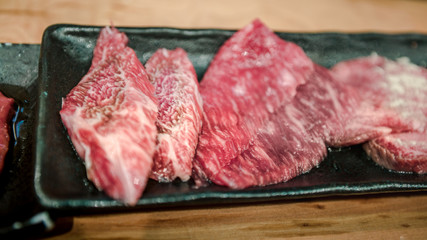 Wagyu beef raw sliced served for japanese barbecue of Sukiyaki. Yakiniku
