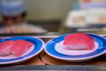 Sushi on conveyor belt in Japan restaurant. Traditional Kaitenzushi Japanese food