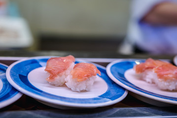 Sushi on conveyor belt in Japan restaurant. Traditional Kaitenzushi Japanese food