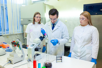 A group of scientists conducts research in a scientific laboratory using advanced technology. COVID-19. COVID Coronavirus