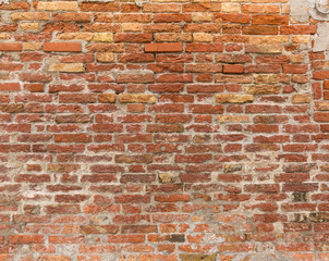 Pattern of a aged brick wall in venice, Italy.