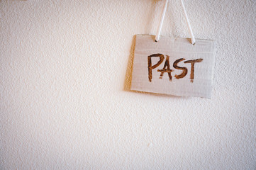 A sign says "Past" on the wall, White