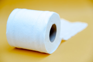 Toilet paper isolated on a yellow background