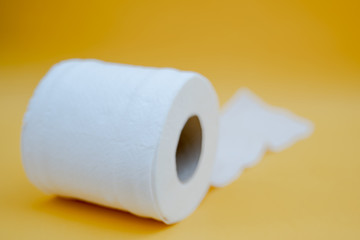 Toilet paper isolated on a yellow background