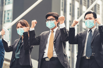 Confident business people with face mask protect from Coronavirus or COVID-19. Concept of help,...