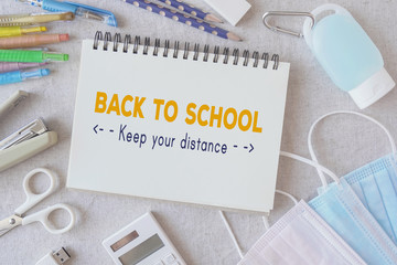 School stationery supplies, medical masks and hand gel sanitizer, school reopening, returning back to school after covid-19 coronavirus pandemic is over, new normal concept
