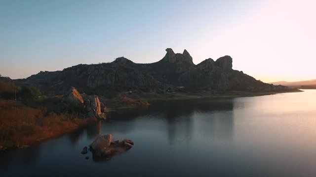 Rocky mountains at the shore of A&ccedil;ude do Cedro (Quixada, northeast Brazil). Sunset time.