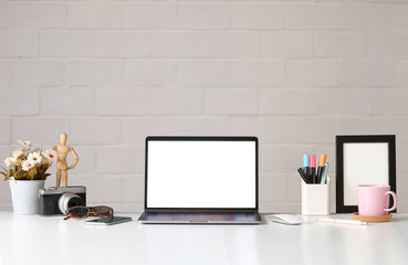 Office desk Workspace stuff with notepad, laptop and coffee cup mouse notepad shot.