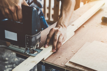 Carpenter working on wood craft at workshop to produce construction material or wooden furniture....