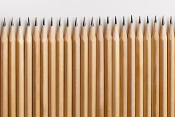 Smooth beautiful neatly sharpened pencils made of wood lie on a white table