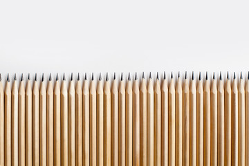 Smooth beautiful neatly sharpened pencils made of wood lie on a white table
