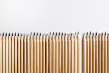 Neatly sharpened stationery pencils made of wood with one missing