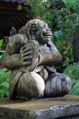 Fototapeta na wymiar Antique Balinese statue on the background of the jungle