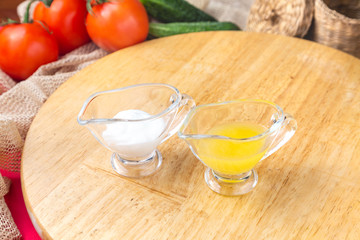 Yellow and white sauces on a wooden board
