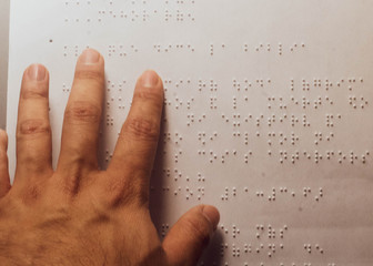 Hand of a person reading in Braille