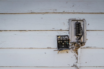 Old style  wooden wall background. electrical couplers Wires and terminals  Painted  white and cracked.