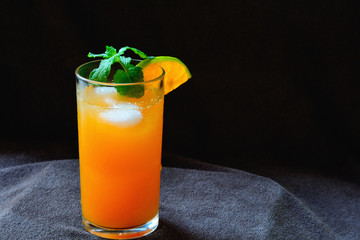 Orange juice on black background.