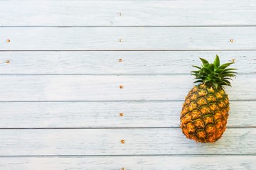 Pineapple on wooden blue background with copy space