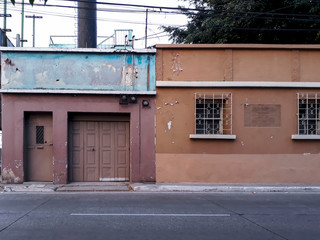 House facades in urban area of ​​Guatemala City at sunset, ocher colors popular homes.
